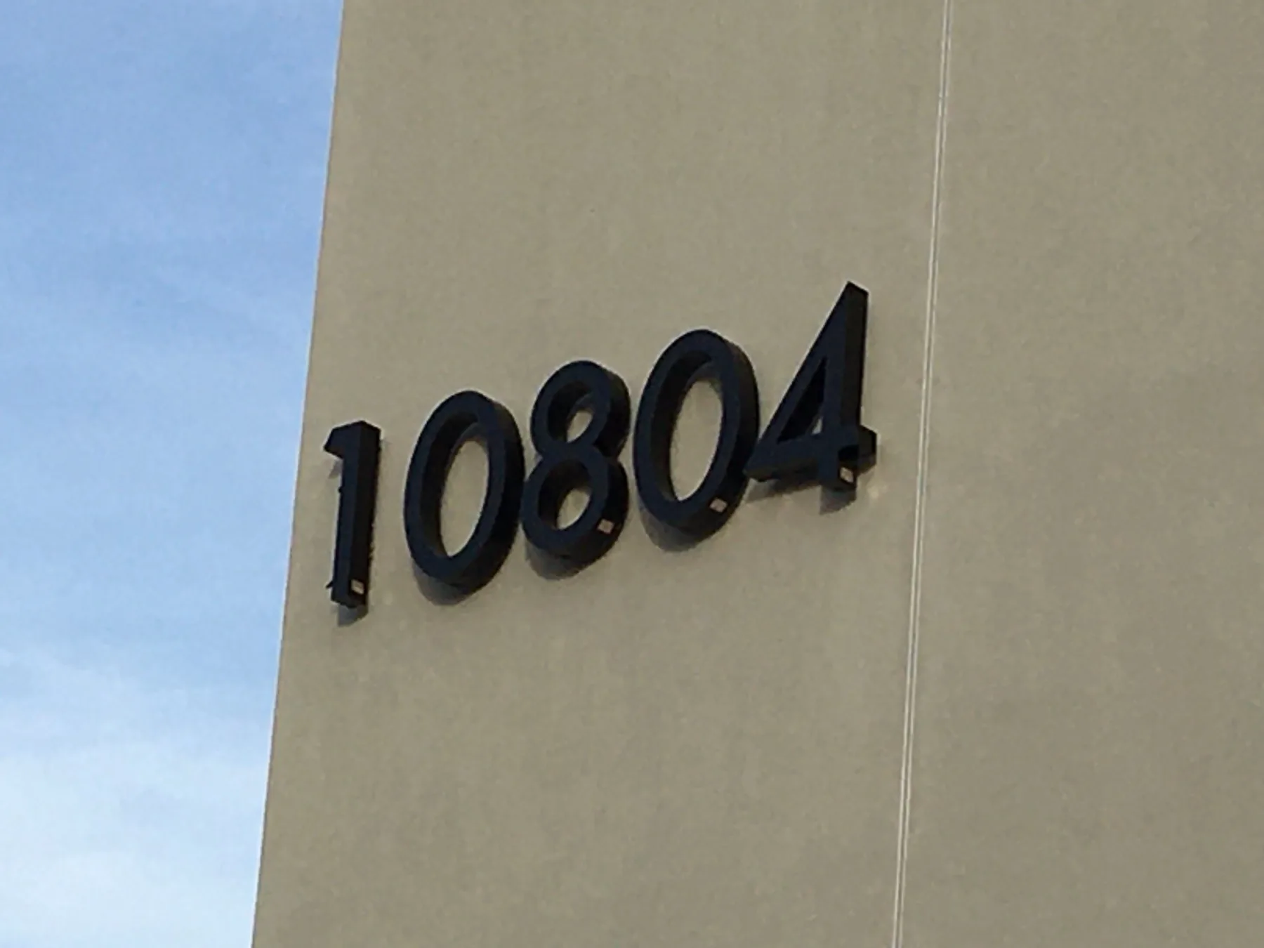 Dimensional address sign on a metal and acrylic surface